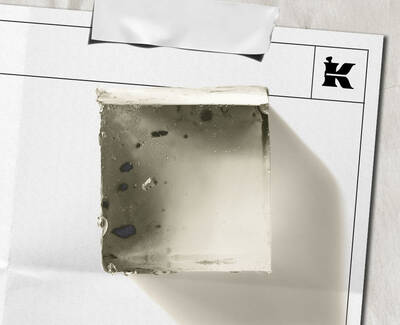  Transparent square soap bar with exfoliating specks, shown on white paper packaging with Kiehl’s logo.